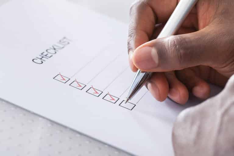 Hand With Red Pen Marking A Check Box